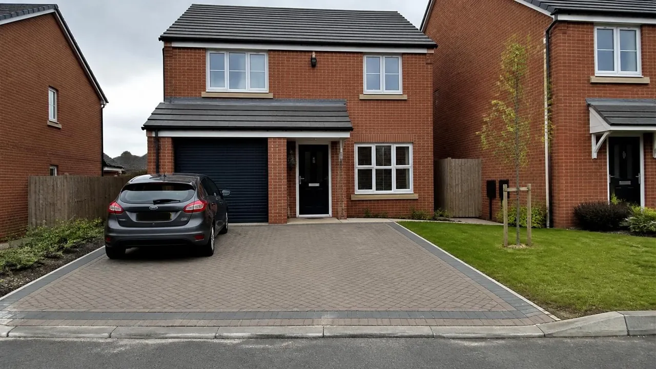 Herringbone block paved double driveway with a charcoal border on a new-build detached house