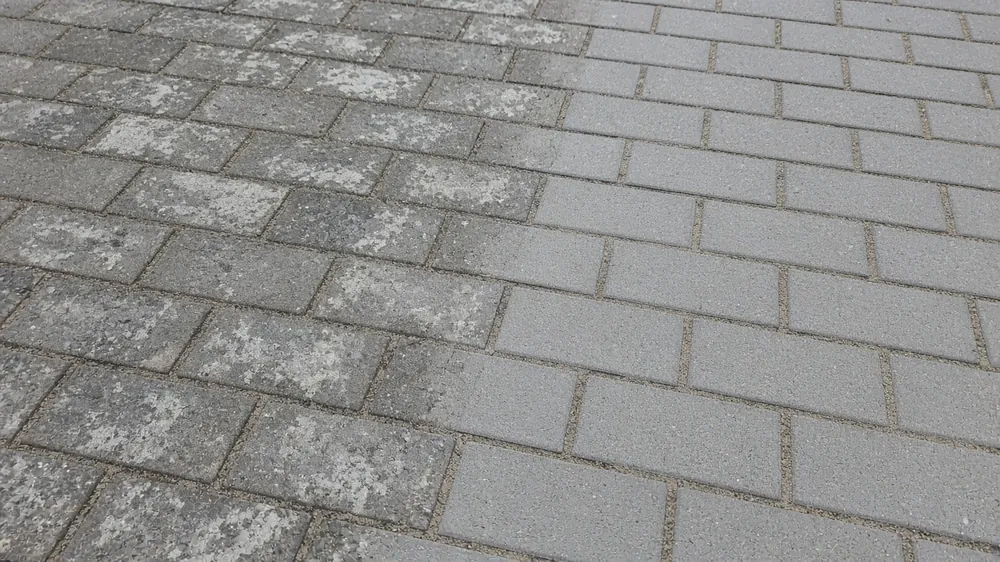 Close-up of new block paving meeting older weathered blocks on a widened drive